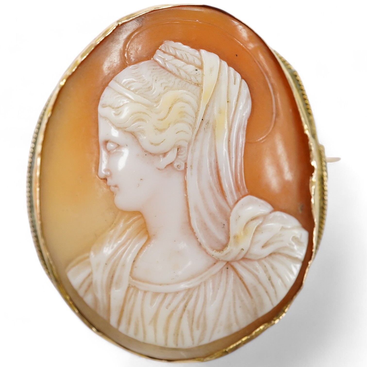 A yellow metal mounted oval cameo shell brooch, carved with the bust of a lady to dexter, 45mm. Condition - fair